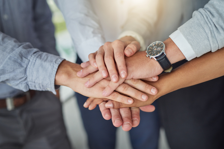 teamwork hands huddle build trust in the workplace